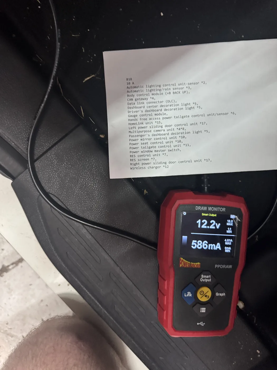 Power Probe draw monitor reading 12.2 volts and 586 milliamps during a parasitic draw test at RepairTech Automotive in Kissimmee, beside a printed circuit legend for fuse B18